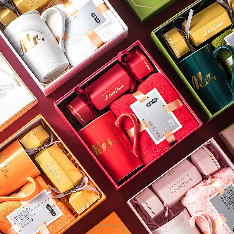 Light luxury ceramic cup gift box set with pink mug, candy, and towel on display