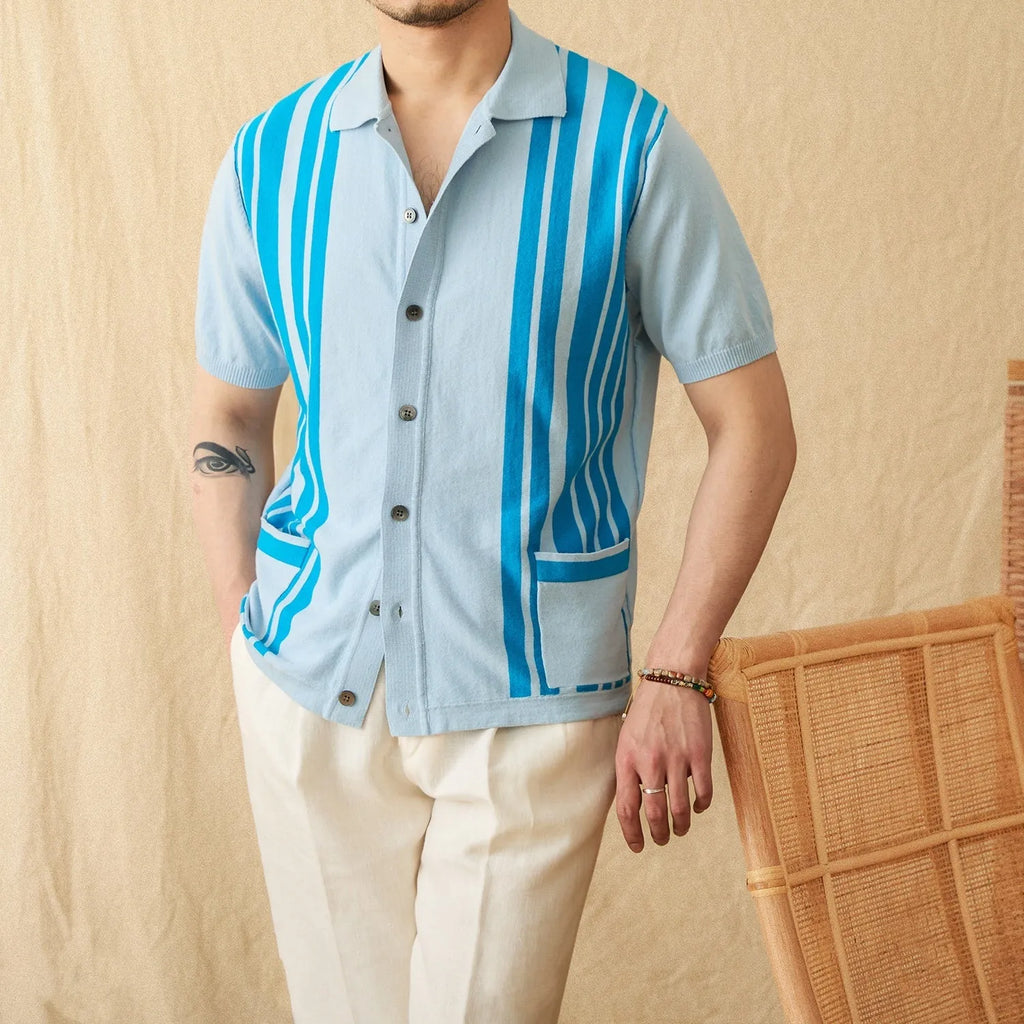 A man wearing a royal blue short-sleeved knitted polo shirt with a lapel collar.