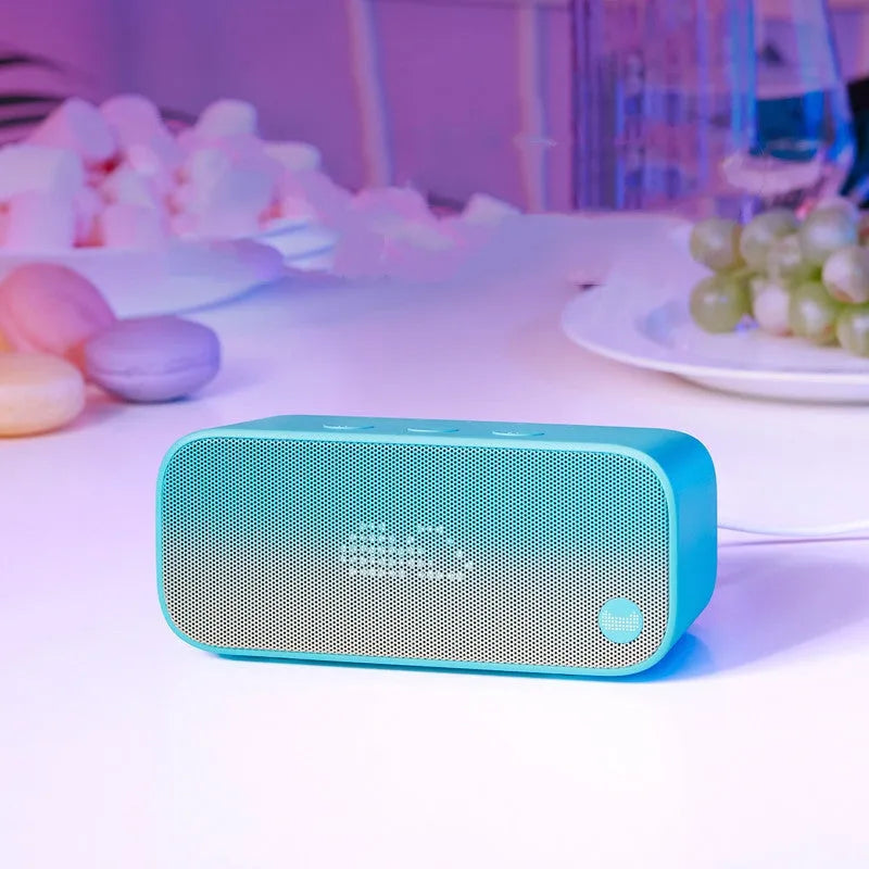 Elf Sugar Cube AI Smart Speaker in choice of colours on a wooden shelf