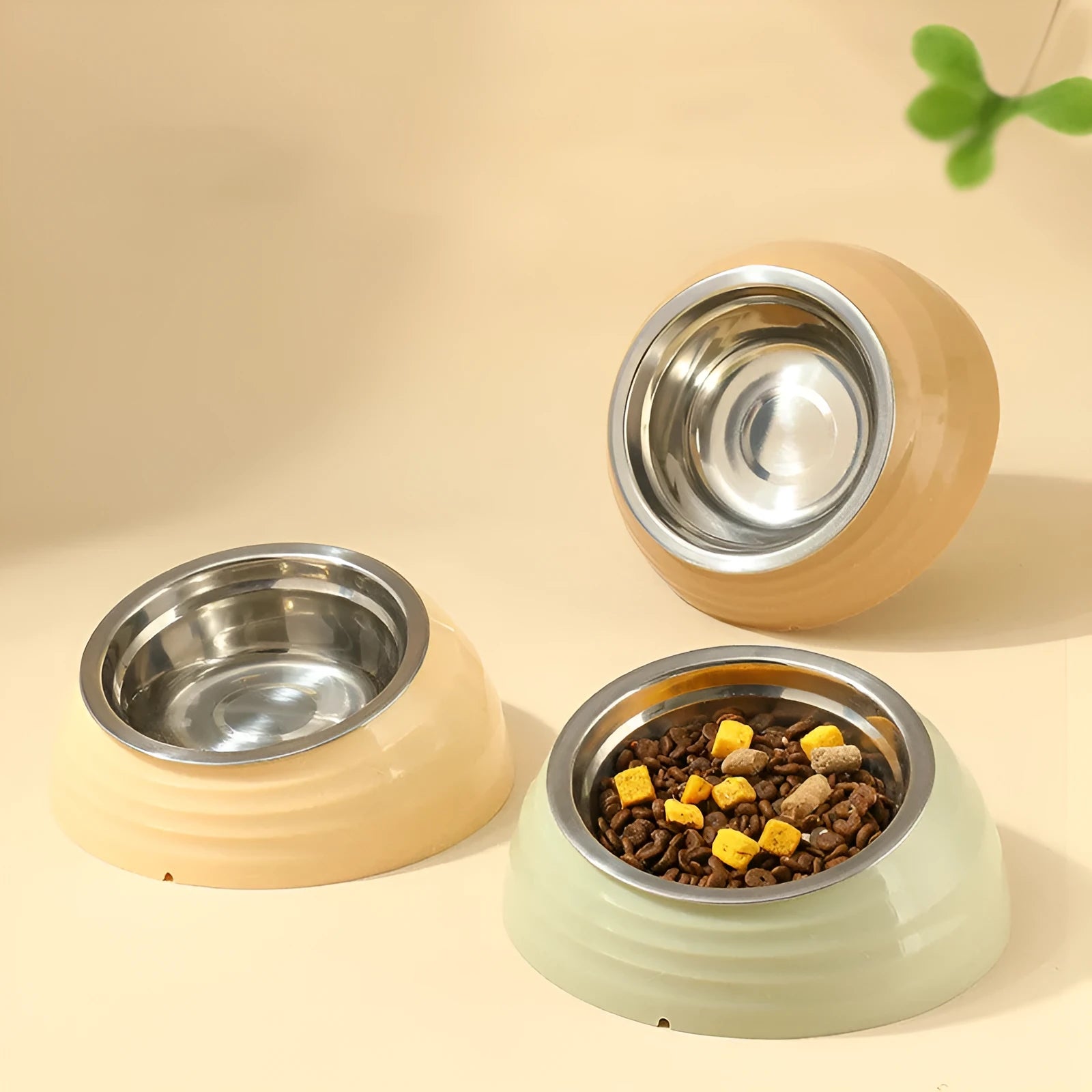 Stainless steel cat bowl on plastic stand in beige, brown, or light green colour