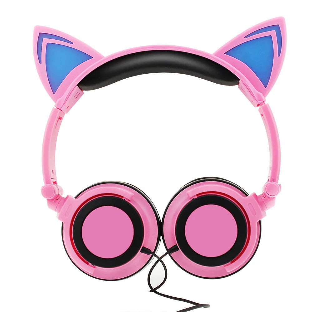 Colourful cat ear headphones with illuminated RGB LED lights in the ears and ear cushions on a black background.