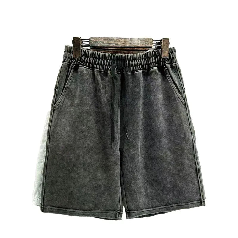 Men's distressed cotton casual shorts in a loose, straight-leg fit, shown in a solid colour.