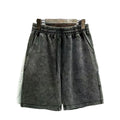 Men's distressed cotton casual shorts in a loose, straight-leg fit, shown in a solid colour.