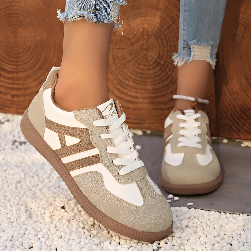 Women's retro colour matching lace-up jogging shoes in black with cross strap and low platform heel.