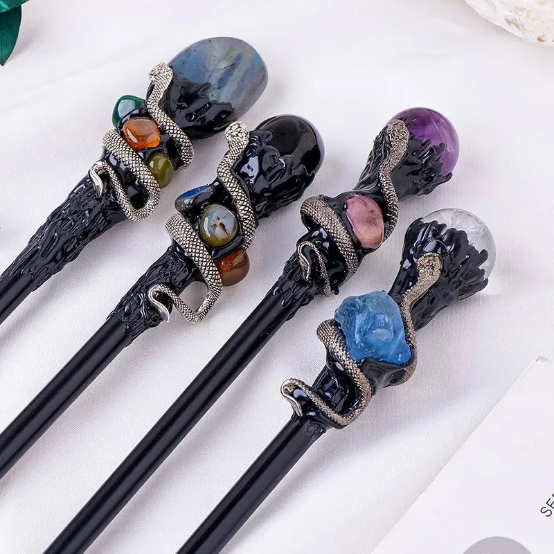 Natural crystal ball truncheon magic wand with amethyst stone ball on dark background