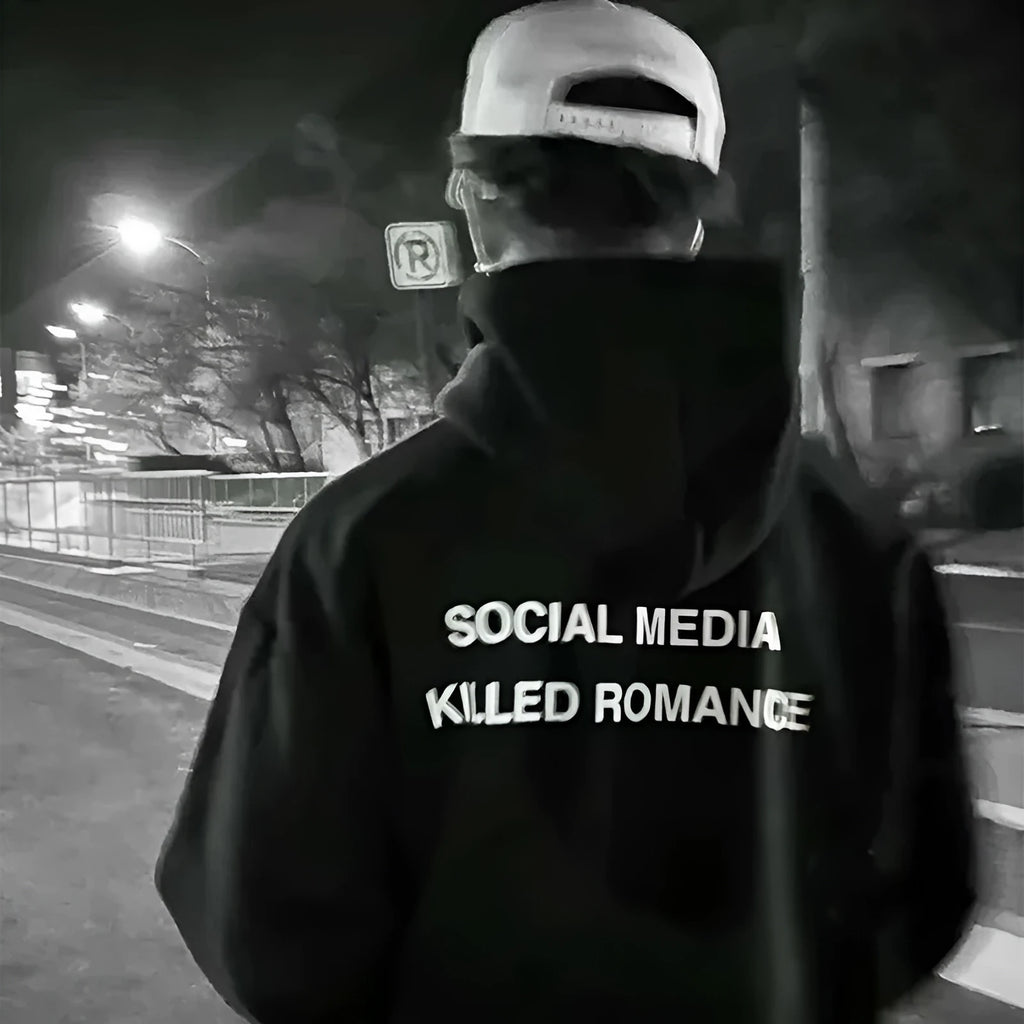 Man wearing a slim fit grey hoodie with a printed spring letter design on the front.