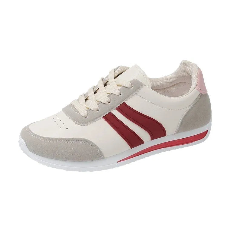 Red and blue low-top lace-up sneakers with rubber sole and mesh upper on white background