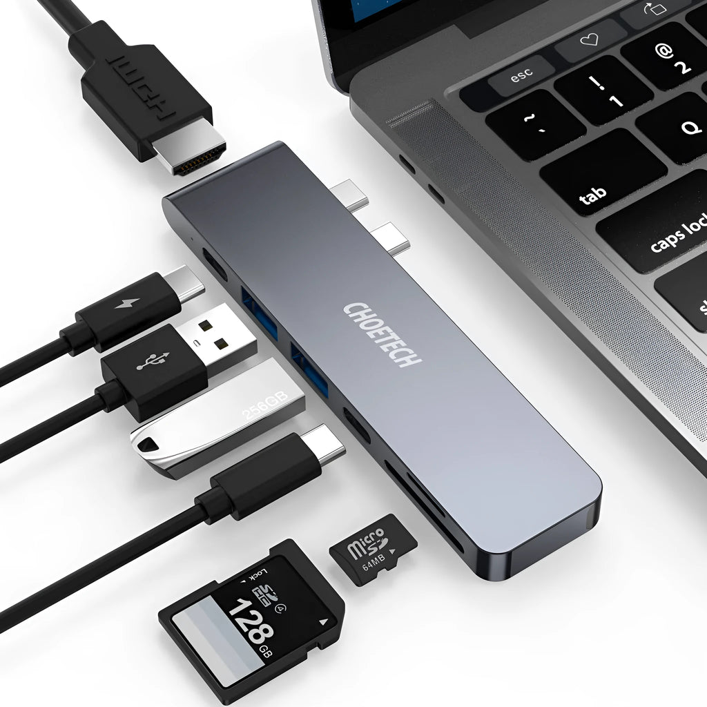 Silver aluminium 7-in-1 USB-C hub adapter with SD card slot, HDMI, USB 3.0, and charging ports.