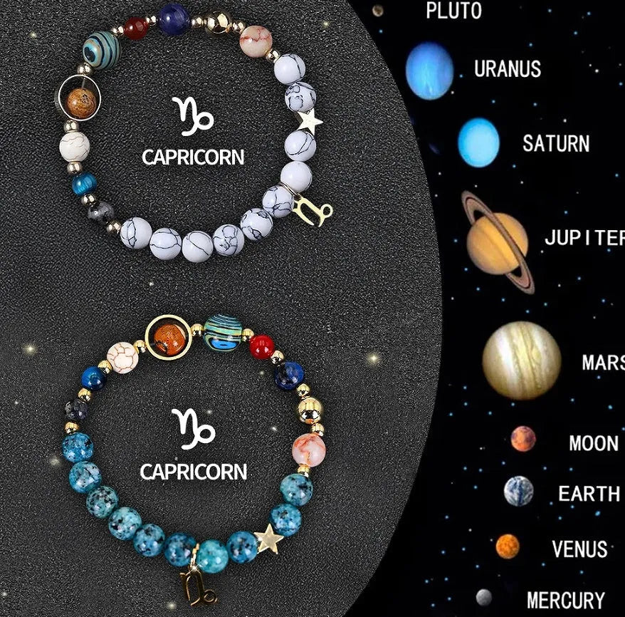 Two natural stone beaded bracelets with zodiac symbol charms on a jewellery display