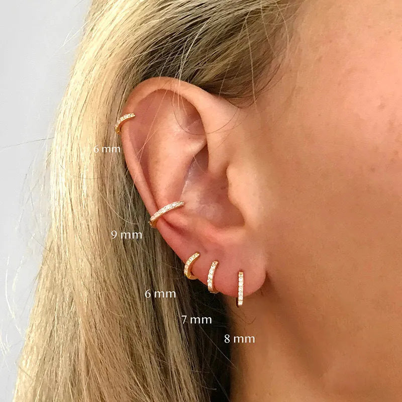 Round zircon geometric stud earrings in gold, rose gold, and silver colours on a white background.
