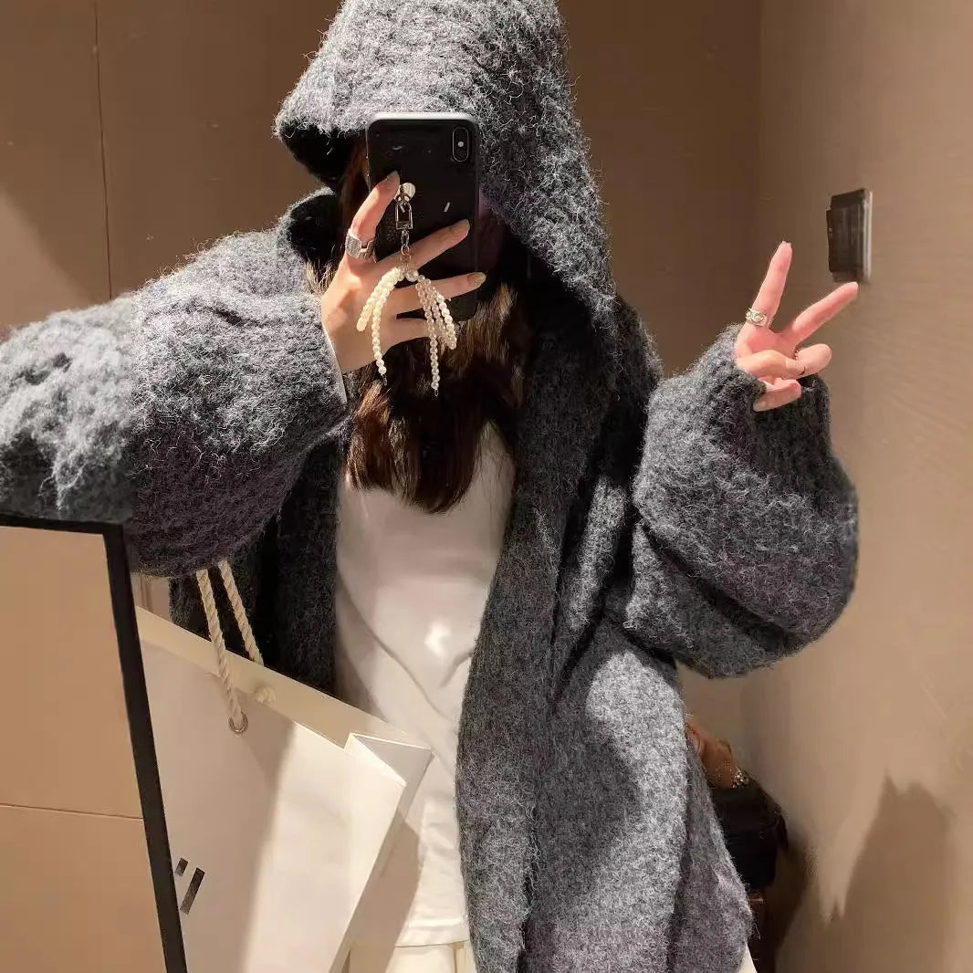 Women's loose-fit hooded cardigan in thick fabric, shown in dark grey, brown, and milky white colours.