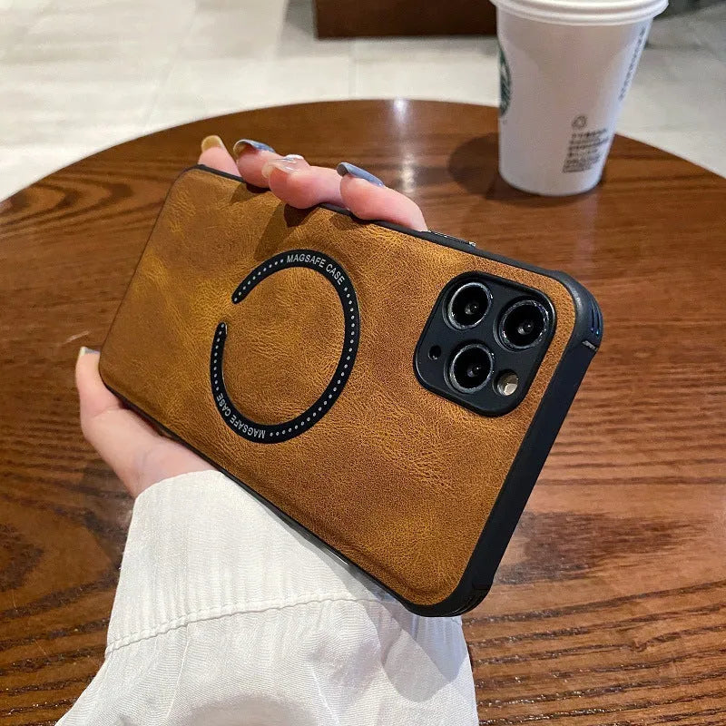 Black imitation leather magnetic charging case for iPhone on a table.