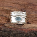 Handmade silver ring with natural aquamarine gemstone, retro geometric shape, on white background