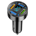 Black four-port USB car charger with digital LED display plugged into a car dashboard socket.