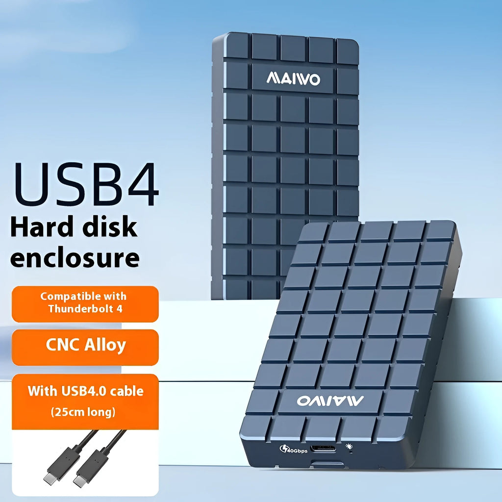 Silver aluminium USB4 hard disk box with connectors, shown next to a notebook computer
