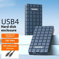 Silver aluminium USB4 hard disk box with connectors, shown next to a notebook computer