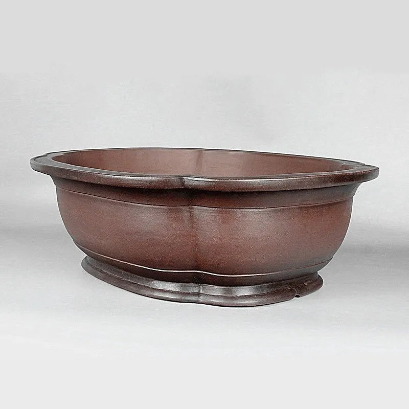 Large antique crabapple-shaped handmade purple clay flowerpot for plants.