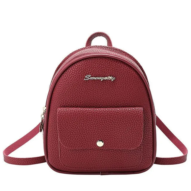 Small black PU women's backpack purse shown as a shoulder bag, with zipper closure and compact size.