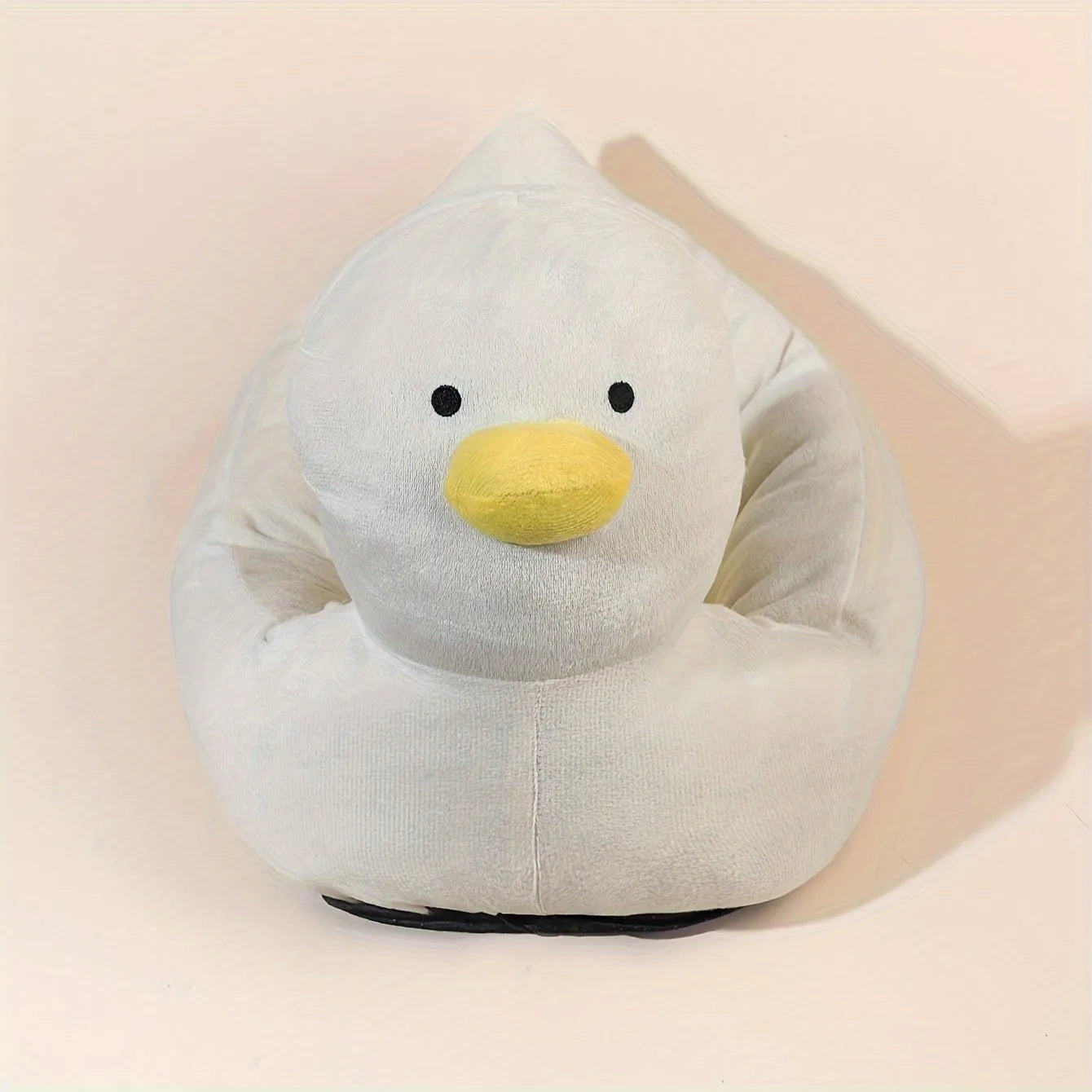 Blue duck-shaped fluffy pet bed sofa for small dogs and cats on a wooden floor.