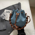 Blue one-shoulder cross body bucket bag with sandwich pocket and synthetic leather lining
