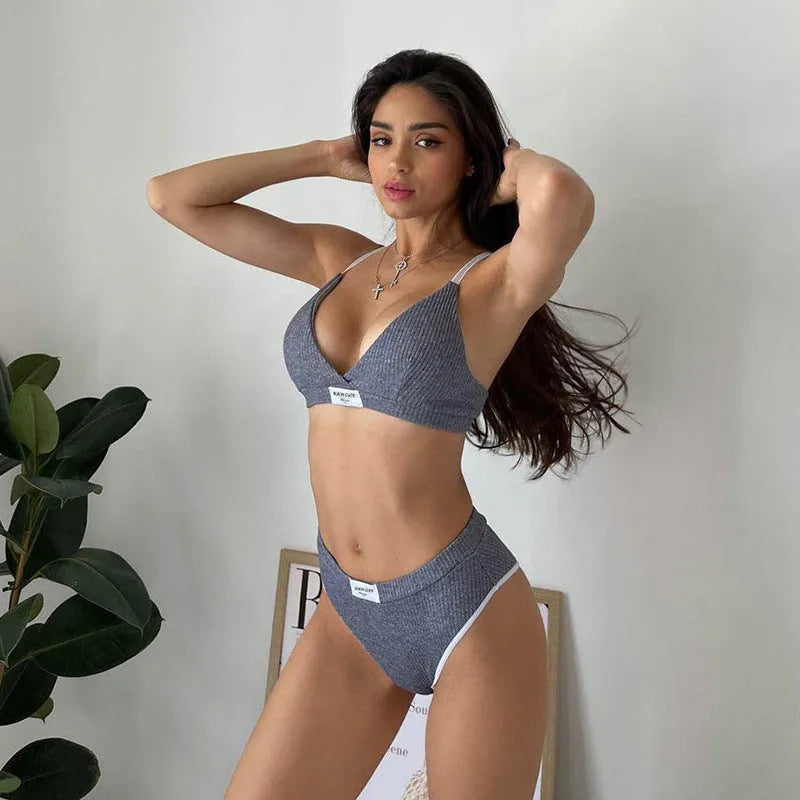 Grey women's bikini set with embroidery and contrast colour binding on a sleeveless top and shorts.
