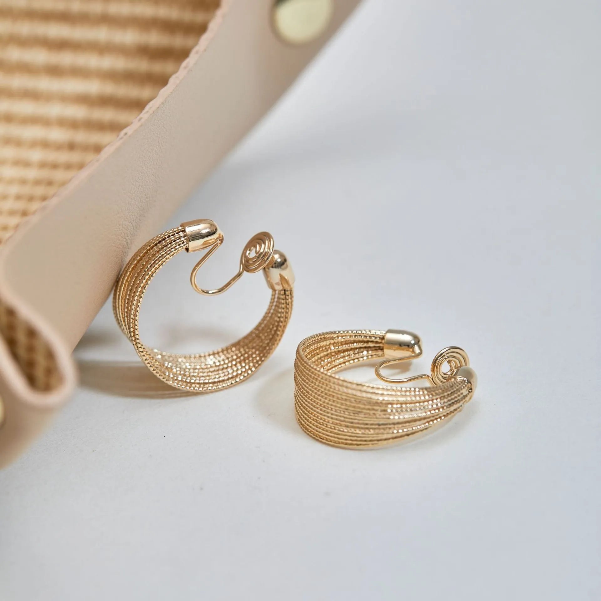Geometric copper bracelet earrings with electroplated silver or gold finish showing stud and clip styles