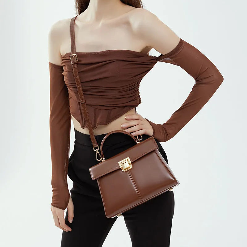 Women's black genuine leather shoulder bag with horizontal square shape and cover opening