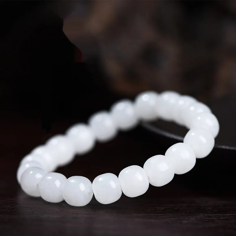 White Hetian jade barrel bead bracelet showing smooth pale stone beads in uniform barrel shape