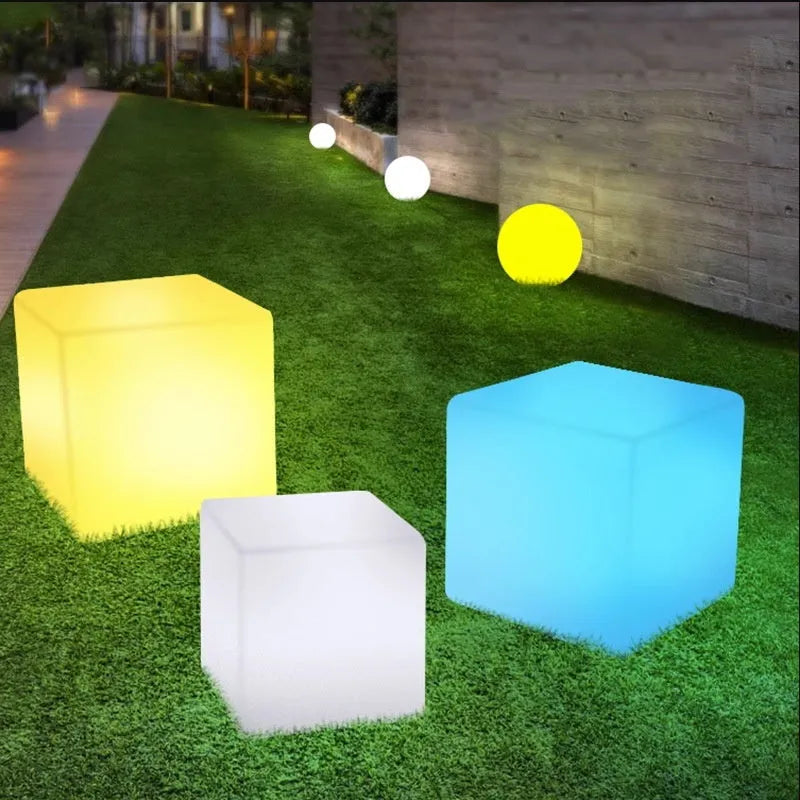 White square LED cube garden light stool with modern design, shown outdoors.