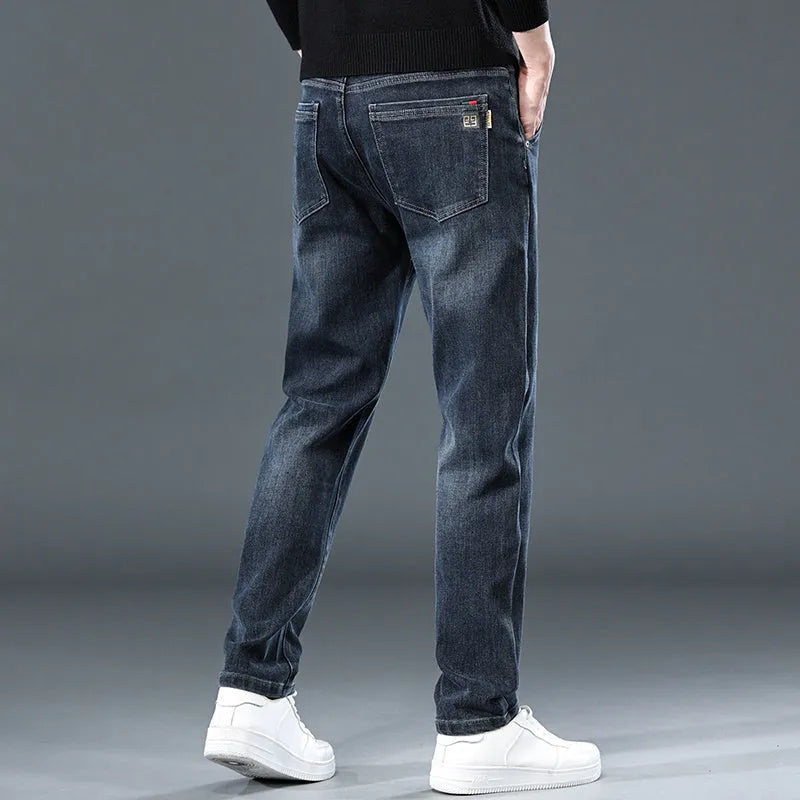 Blue grey slim straight leg casual trousers on a hanger, showing the mid-rise waist and zipper fly.