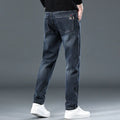 Blue grey slim straight leg casual trousers on a hanger, showing the mid-rise waist and zipper fly.