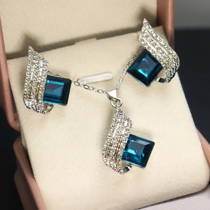 Women's necklace and earring set with glass pendant on cross chain, alloy material with electroplated finish