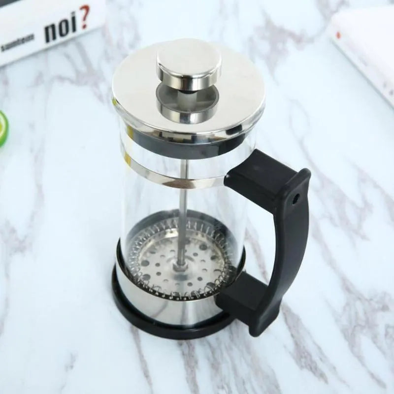 Compact glass and stainless steel manual pour-over coffee maker with 350ml capacity.