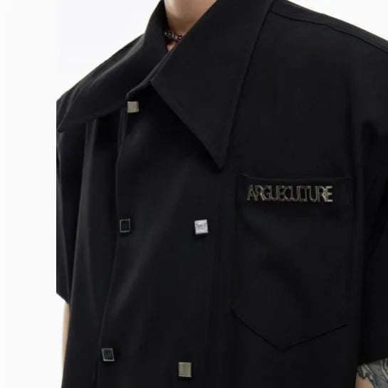 Men's loose-fitting short-sleeved casual summer shirt in black, showing splicing detail and lapel collar.