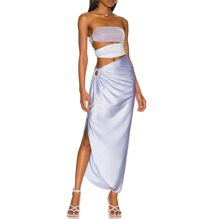 Purple women's one-piece swimsuit with matching wrap skirt on beach