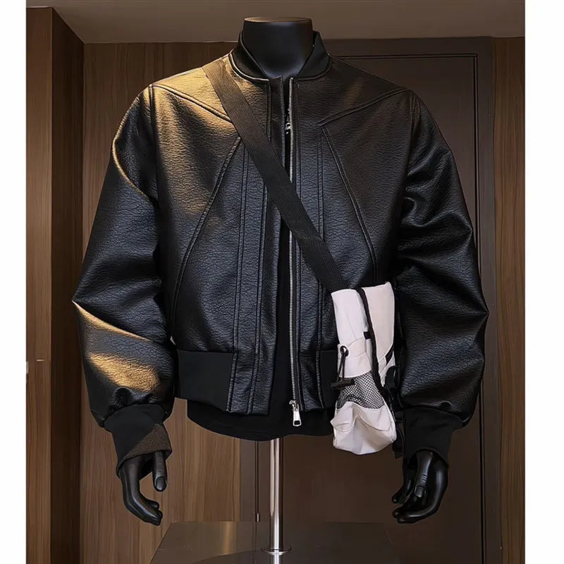 Man wearing a black PU egg white leather jacket with an extended length and tight light business fit.