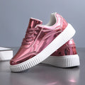 Gold sequinned unisex platform sneaker with thick sole and stitching detail on a white background.