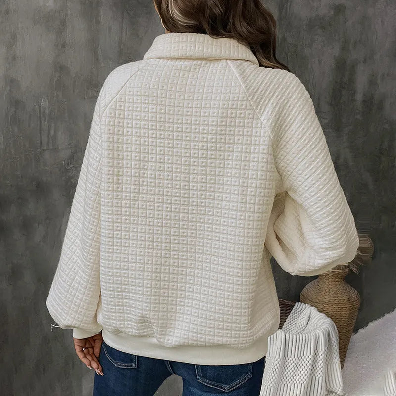 Women's beige textured polo collar long sleeve polyester sweater on a hanger.