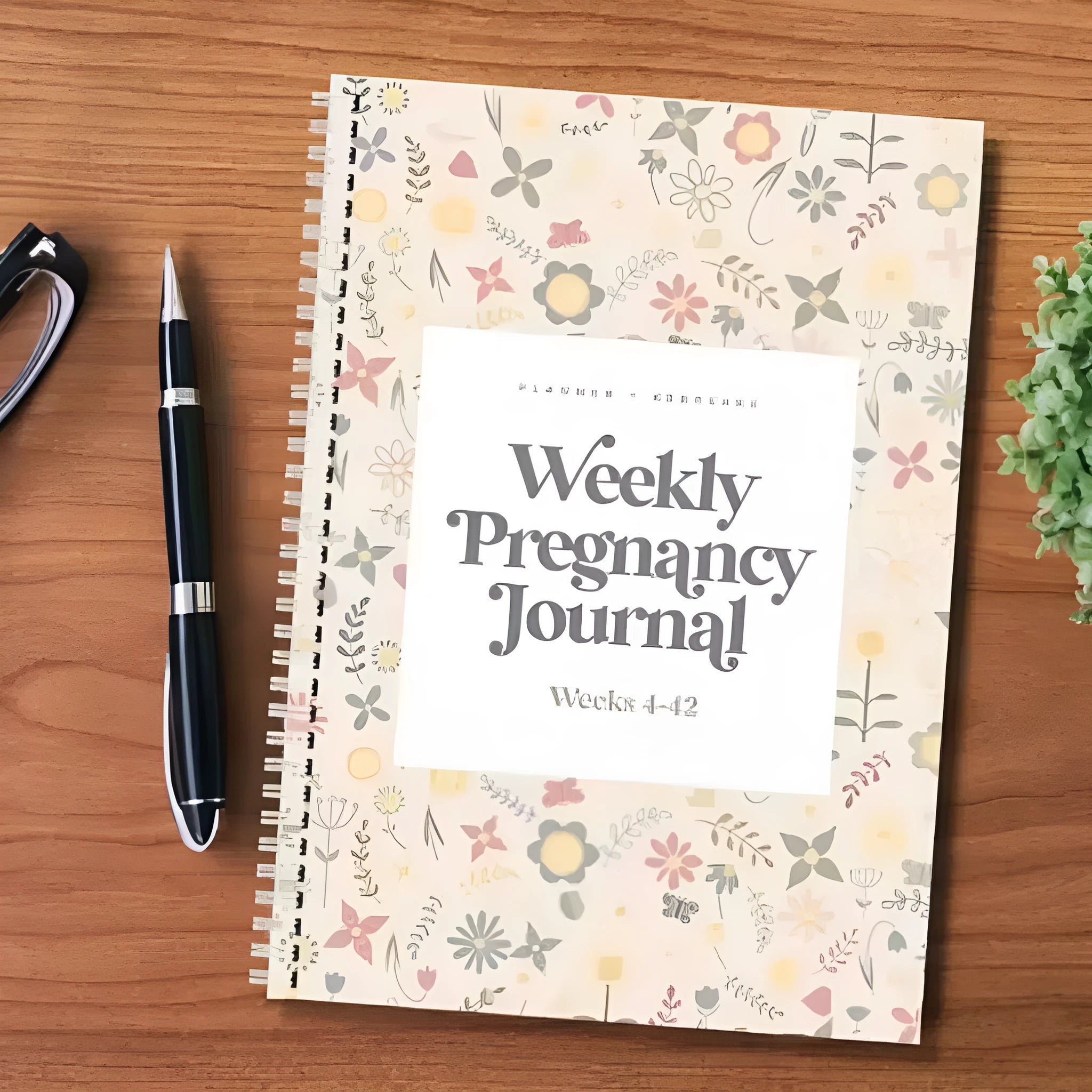 A5 pregnancy diary notebook open to weekly pregnancy tracking pages