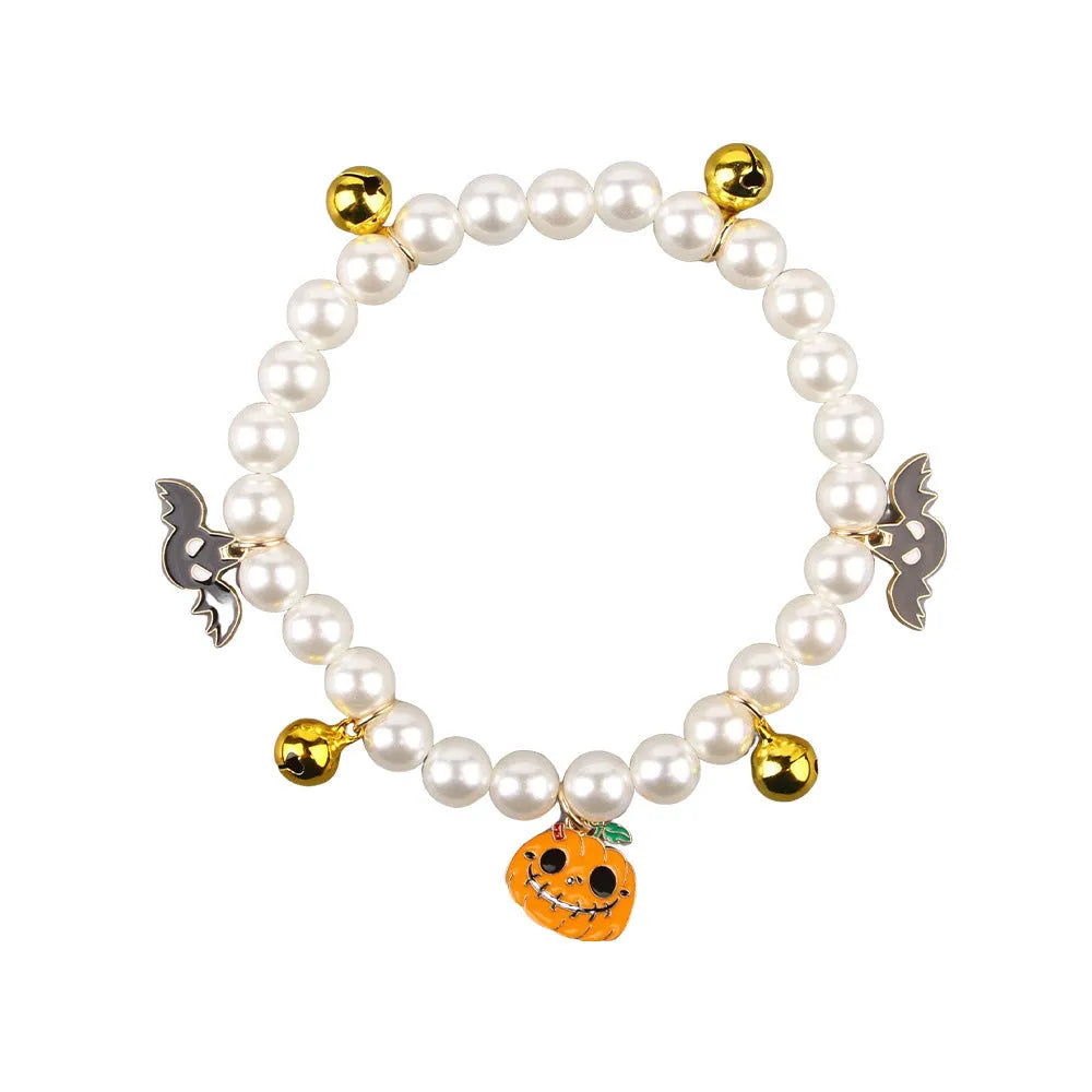 Halloween cat collar with simulated pearls and pumpkin designs including purple ghost, skull, and smiling pumpkin patterns