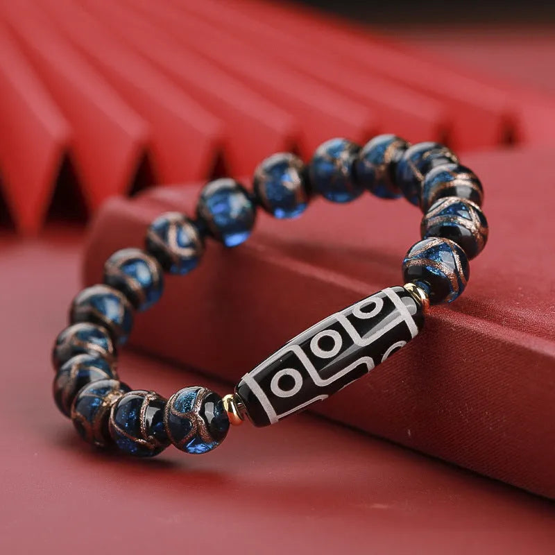 Close-up of a colourful handcrafted Chinese bracelet with snake lucky beads and auspicious patterns.