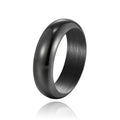Glossy electroplated titanium steel ring in gold colour on a plain background.