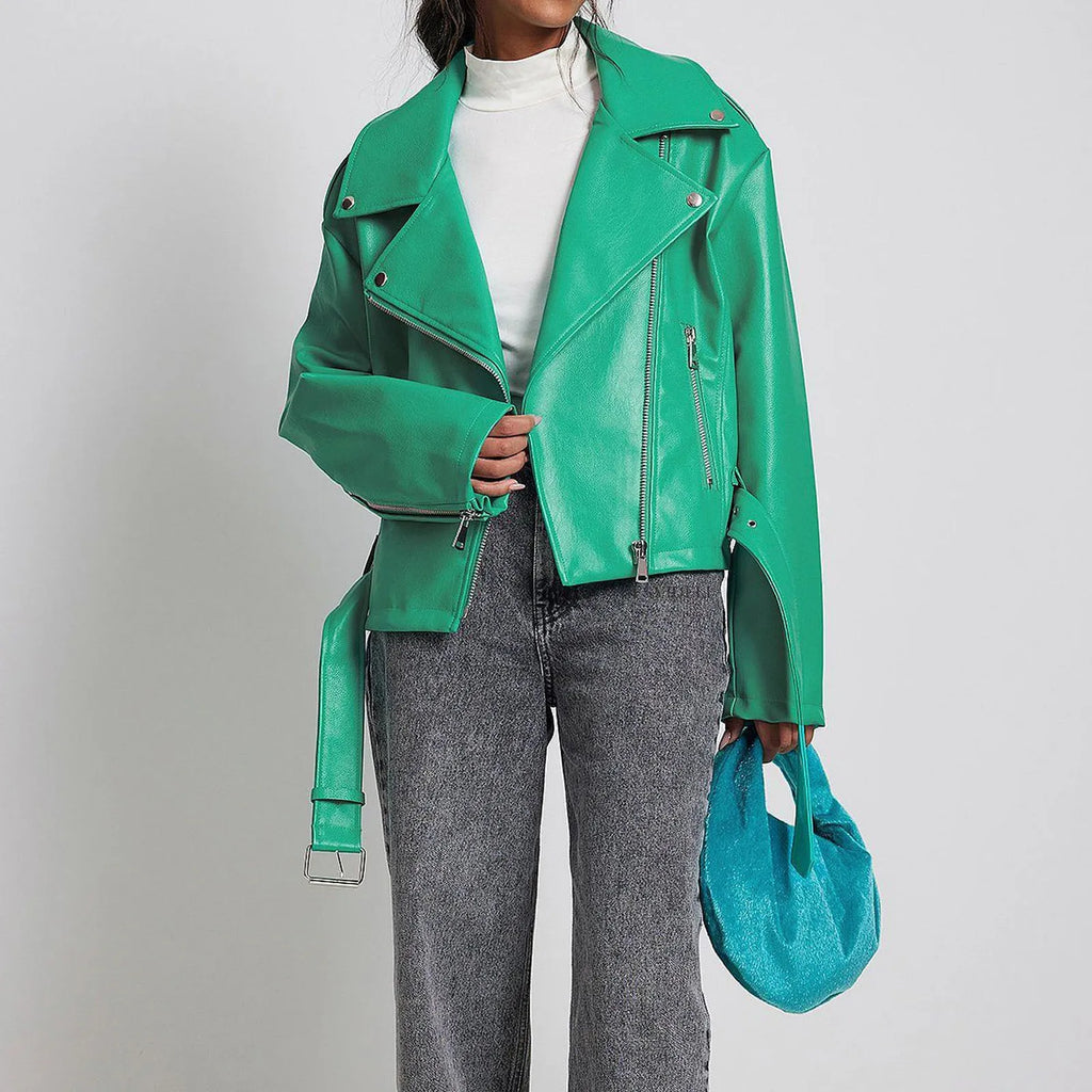 Black punk style jacket with a short belt, lapel, and Peter Pan collar on a hanger.