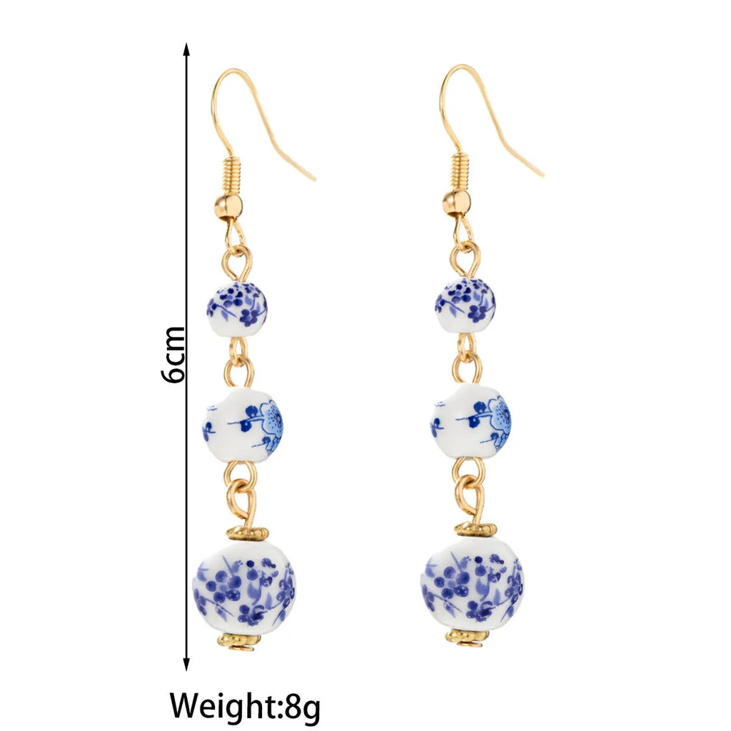 Blue and white porcelain ceramic bead retro earrings with geometric alloy components