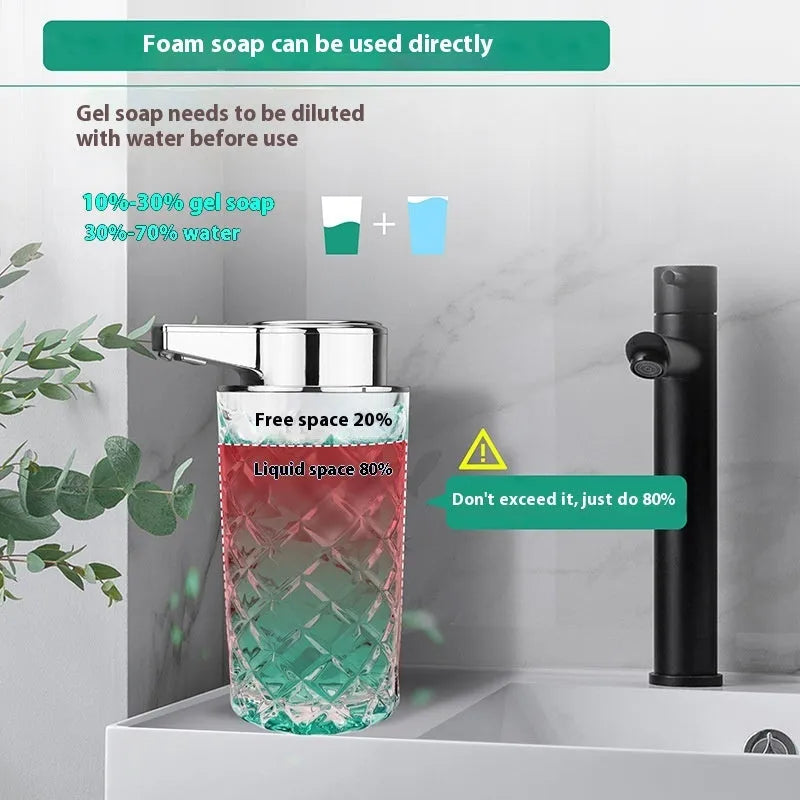 Silver automatic sensor soap dispenser with USB-C charging port on a bathroom countertop.