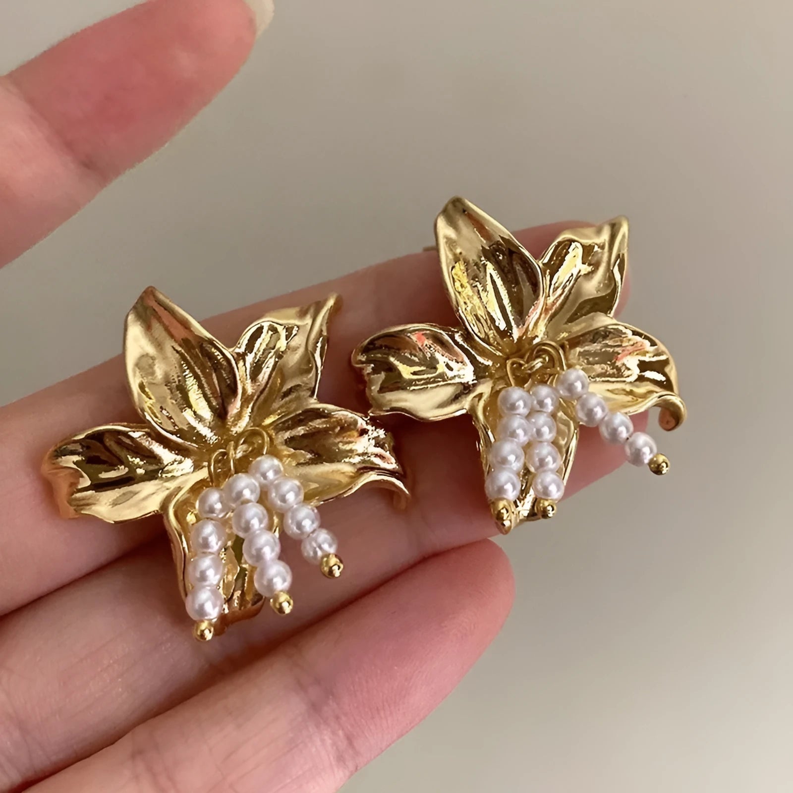 Gold H1795 colour exaggerated pearl flower earrings with metal construction and floral design elements
