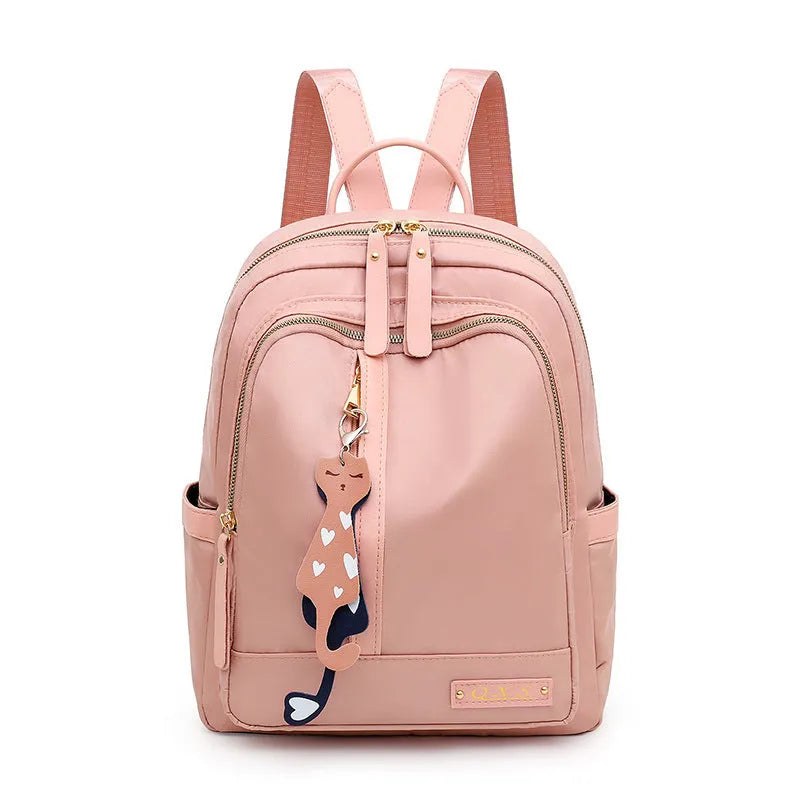 Black or pink women's casual nylon backpack with soft handle, showing internal zipper pockets and double shoulder straps.