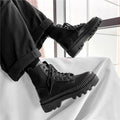 Men's smooth black leather Doc Martens platform boots with side zipper and chunky sole.