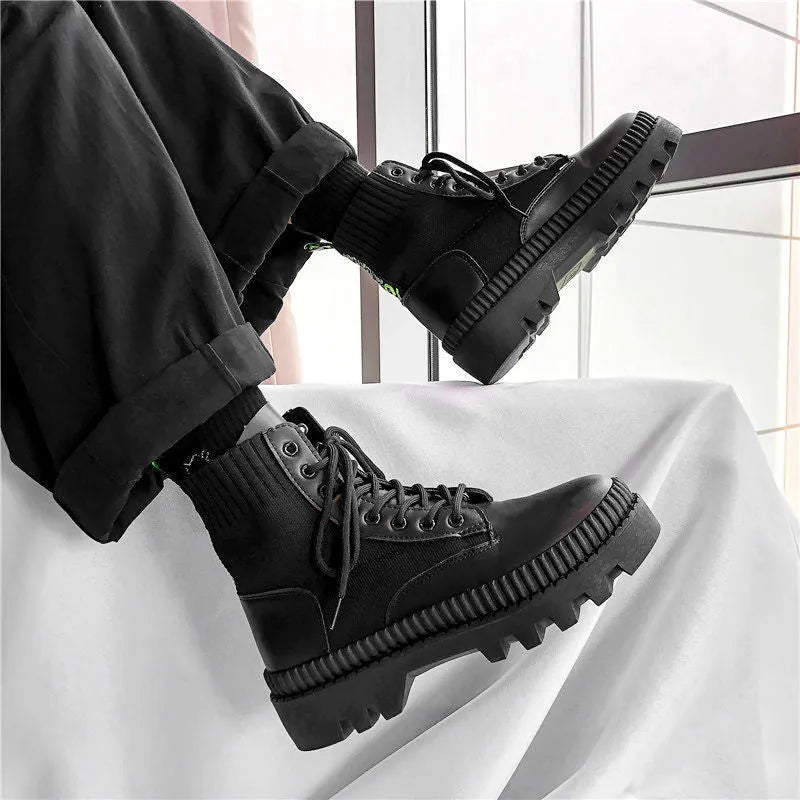 Men's smooth black leather Doc Martens platform boots with side zipper and chunky sole.