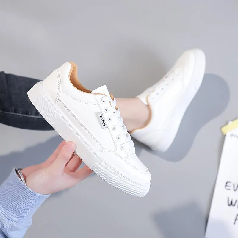 Korean-style white low-top women's sneakers made from artificial PU leather with a plastic sole.